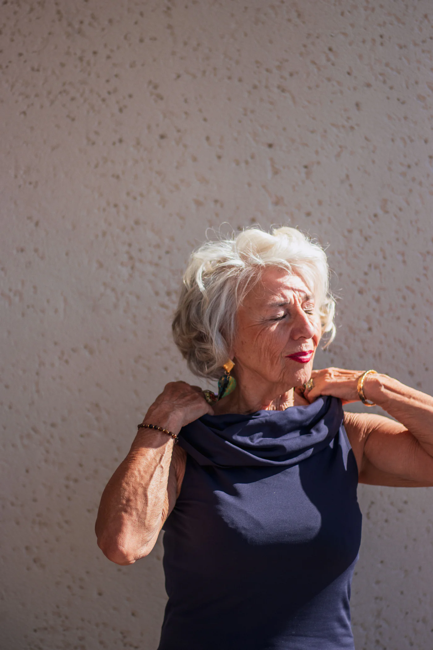 Maureen, 76, stretching her shoulders before a session